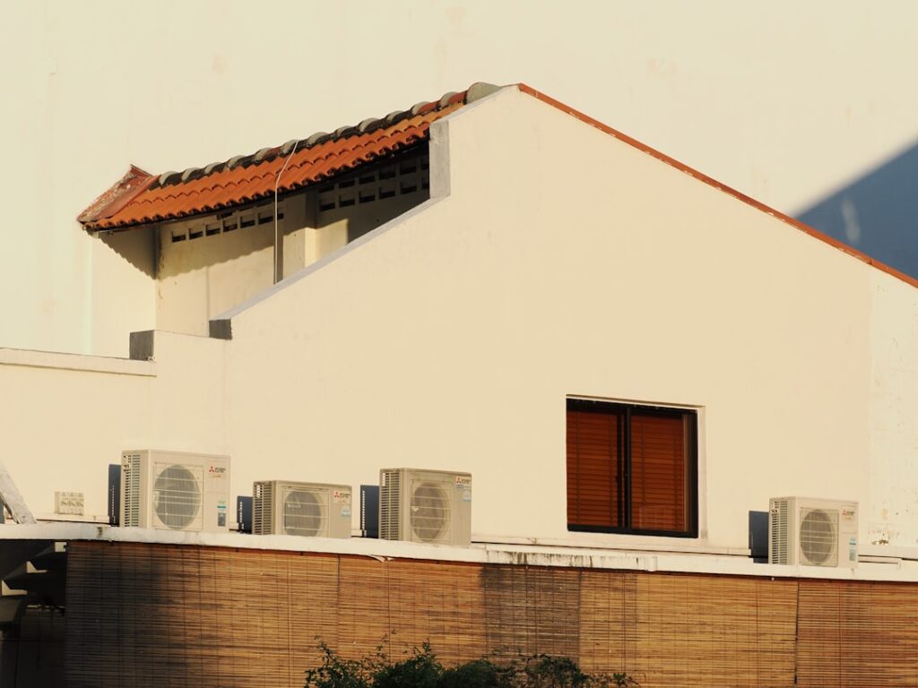 The Homeowner Guide to Not Getting Steamed by SEER2 Ratings 4 modern energy-efficient air conditioning unit outside a home - understanding seer2 ratings and ac efficiency